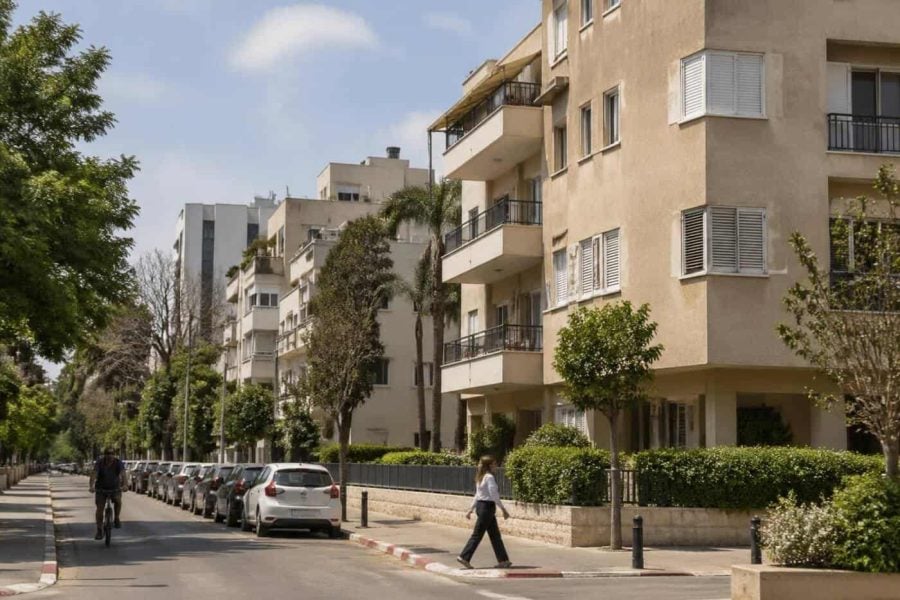 Mid-rise apartment buildings on a tree-lined residential street in Givatayim